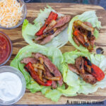 wood board with lettuce wrap fajitas and topping