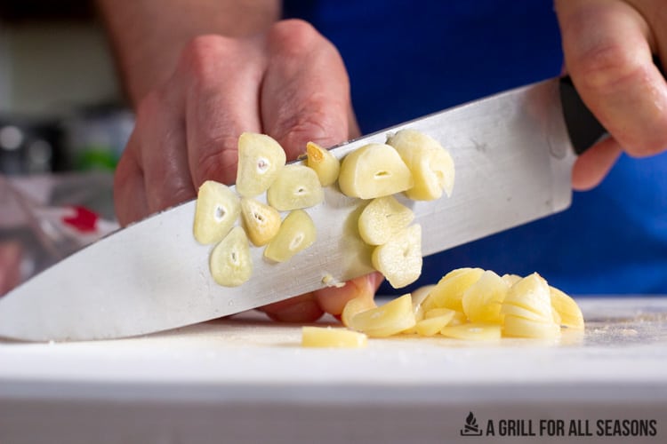 hands cutting garlic