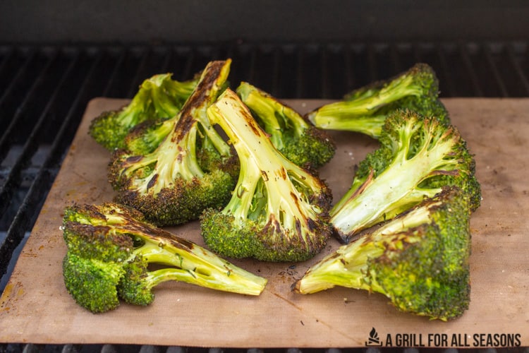 grilled broccoli on a grill mat on the grill