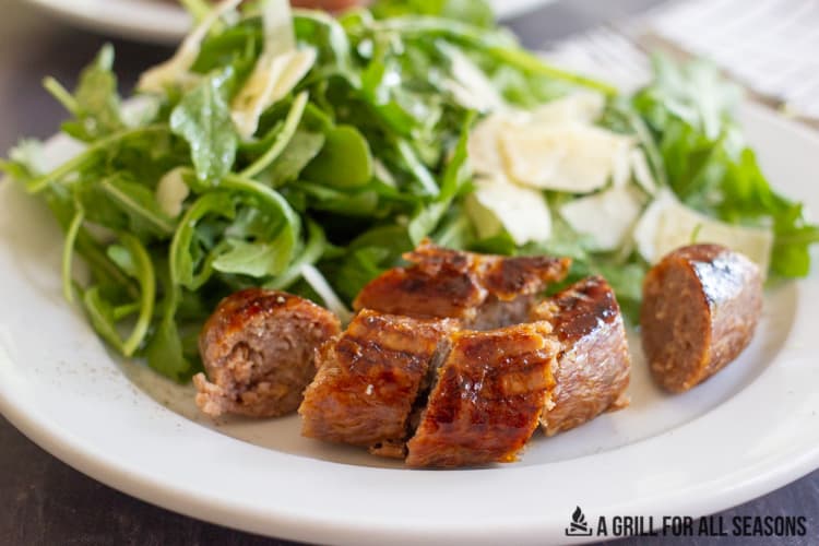 close up of sliced air fryer sausage with a salad