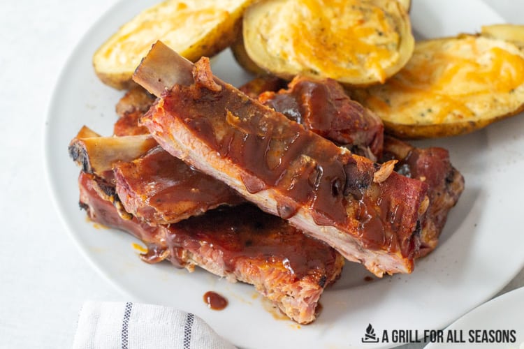 pellet grill ribs on a plate with potatoes