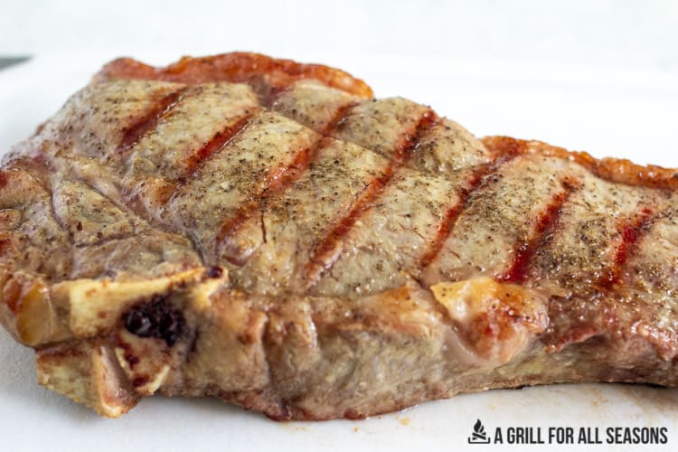 grilled steak on a cutting board with grill lines