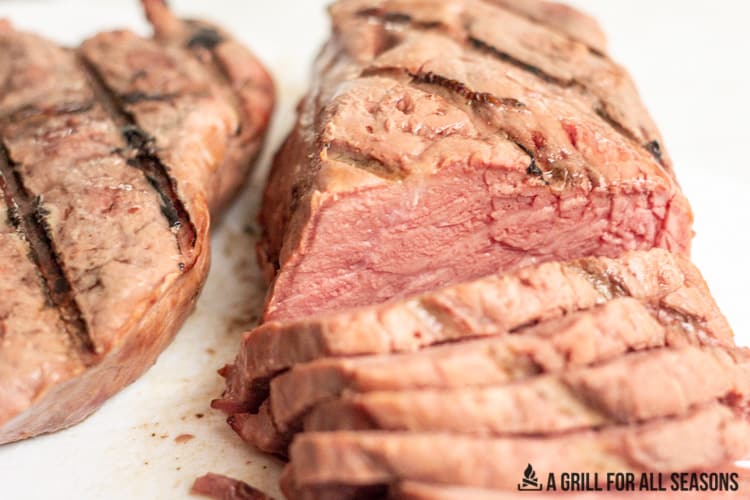smoked sirloin steak sliced on a cutting board