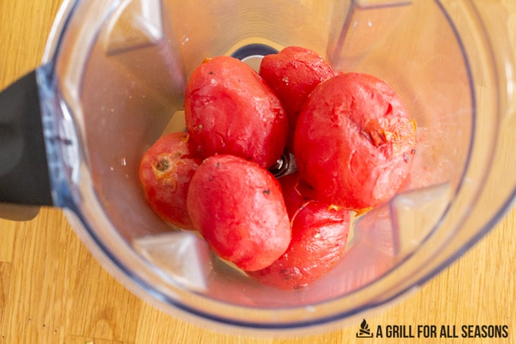 Smoked, skinless plum tomatoes in a blender.