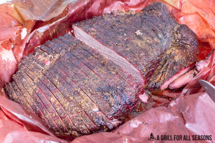 sliced smoked beef brisket on butcher paper