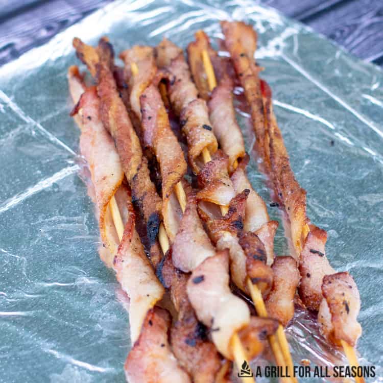 Cooked bacon on a stick.
