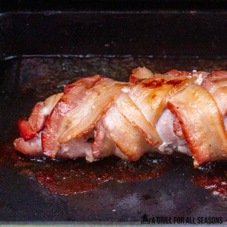Pork tenderloin wrapped in bacon and smoked. Being seared on cast iron skillet.