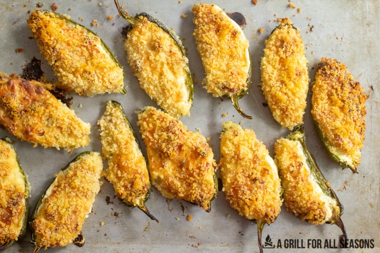 Smoked jalapeno poppers done cooking on baking sheet.