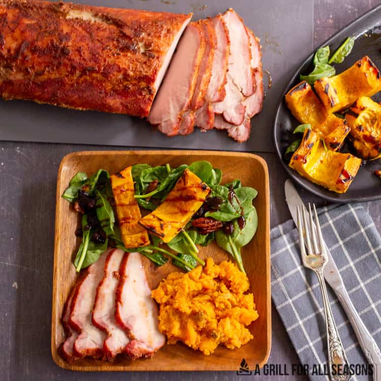 traeger smoked pork loin being served with mashed sweet potatoes and grilled delicata squash