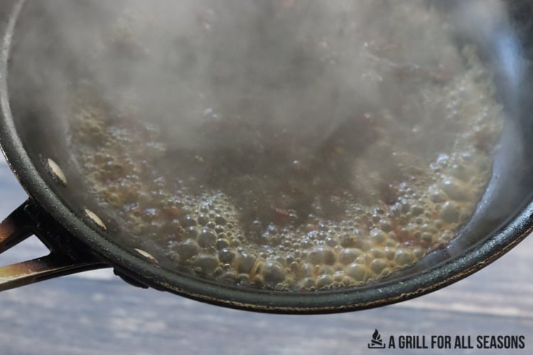 Deglazing frying pan with bourbon.