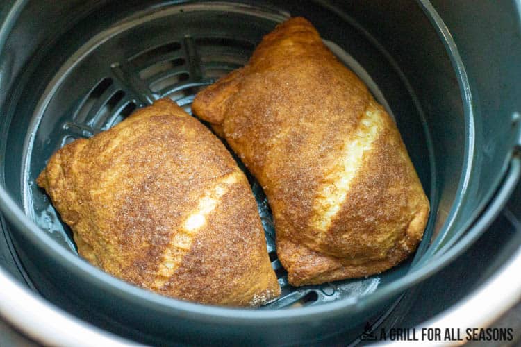 close up of cheese pastries in air fryer basket