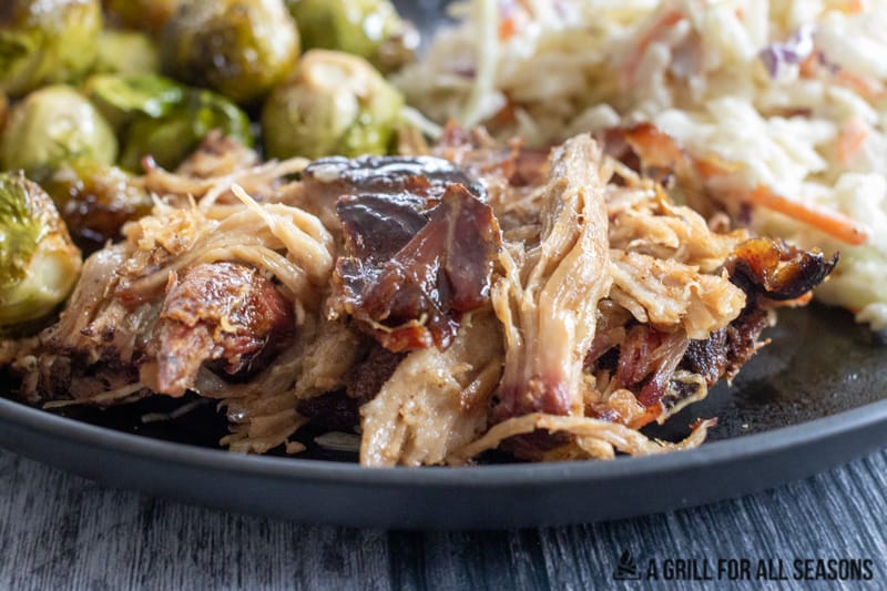 Plate with traeger pulled pork , coleslaw and brussels sprouts.