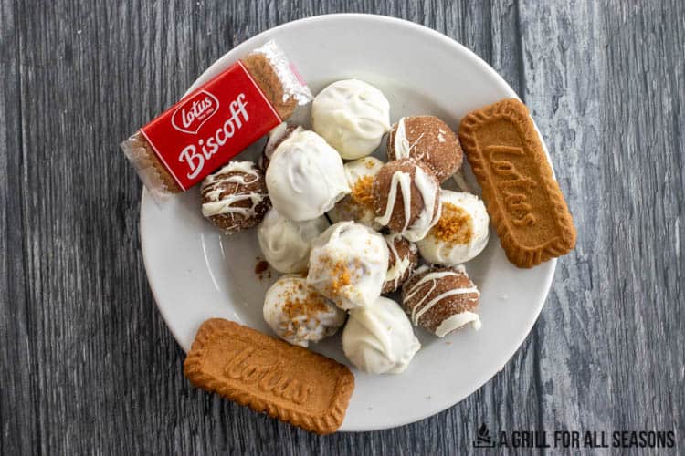 plate of biscoff truffles next to package of lotus biscoff cookies and whole biscuits