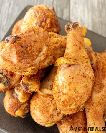 close up of smoked chicken legs on platter