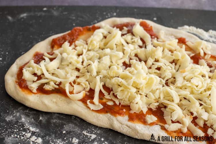 pizza dough with sauce and cheese