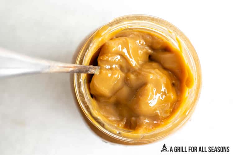 jar of thick caramel sauce seen from overhead