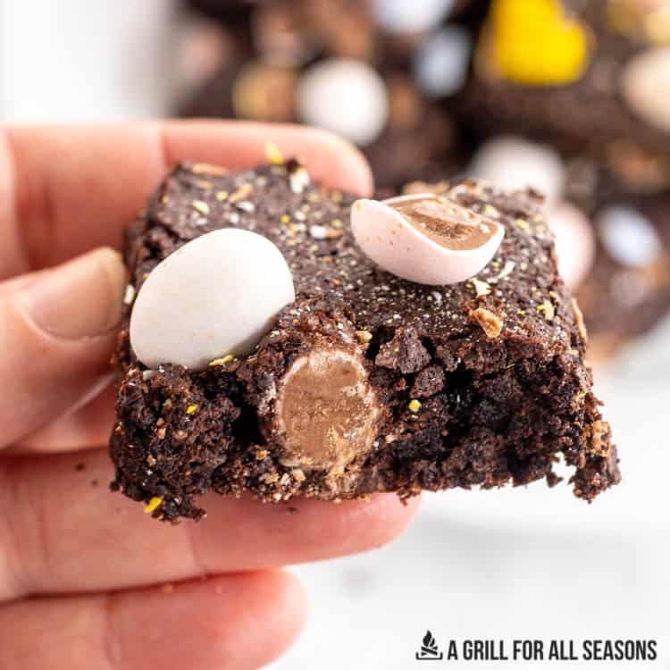 close up of hand holding one of the mini egg brownies