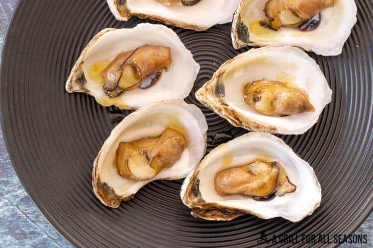 close up of smoked oysters on serving plate