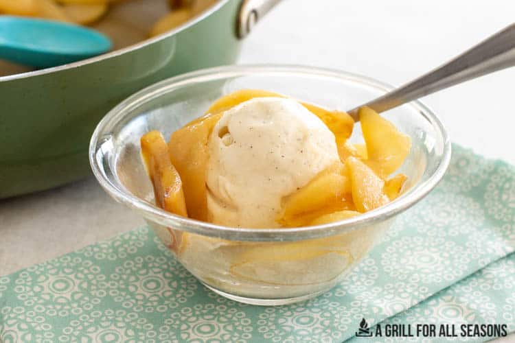bowl of stewed pears and ice cream in front of skillet