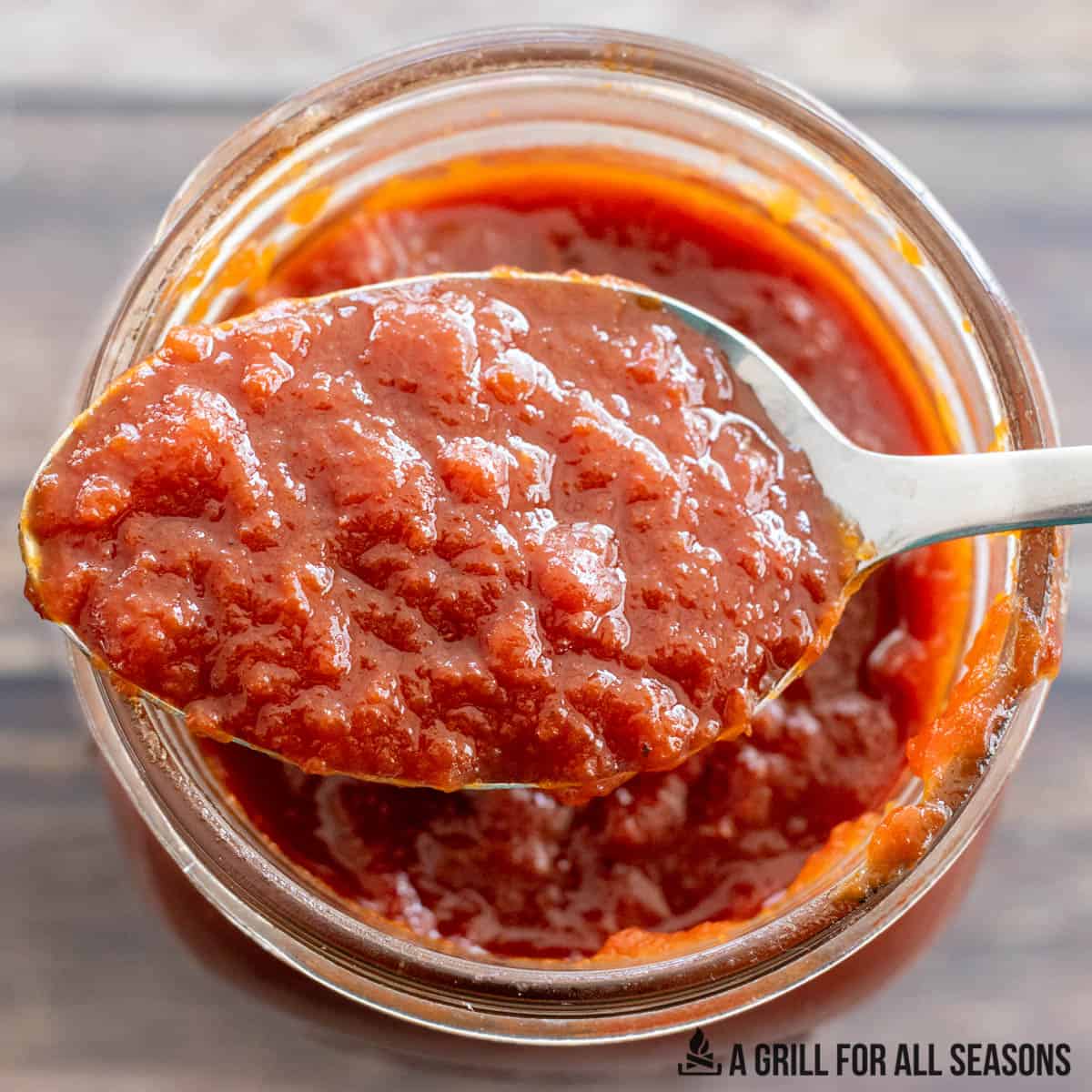 sweet bbq sauce on a spoon close up