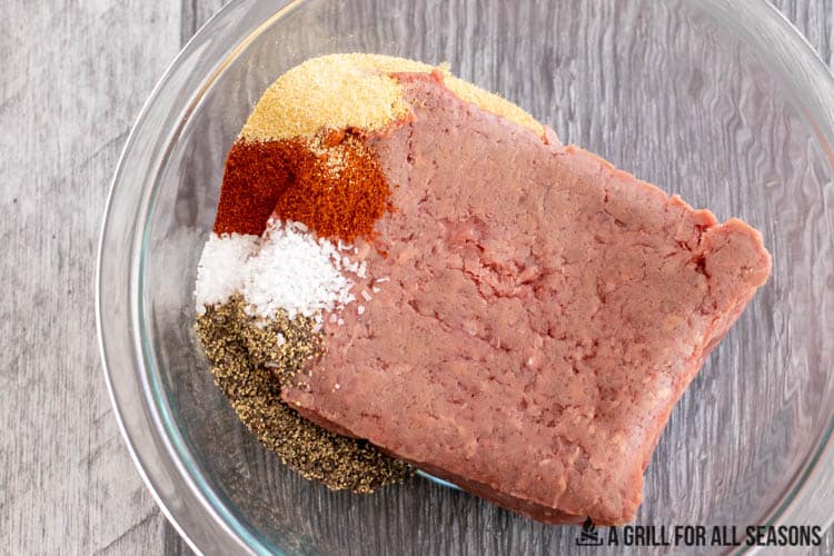 ground bison and seasonings in bowl to use in ground bison recipes