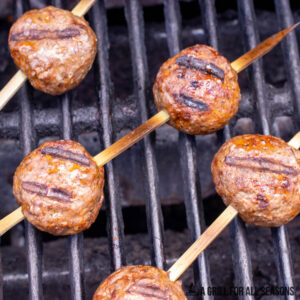 bison meatbealls on skewers on grill
