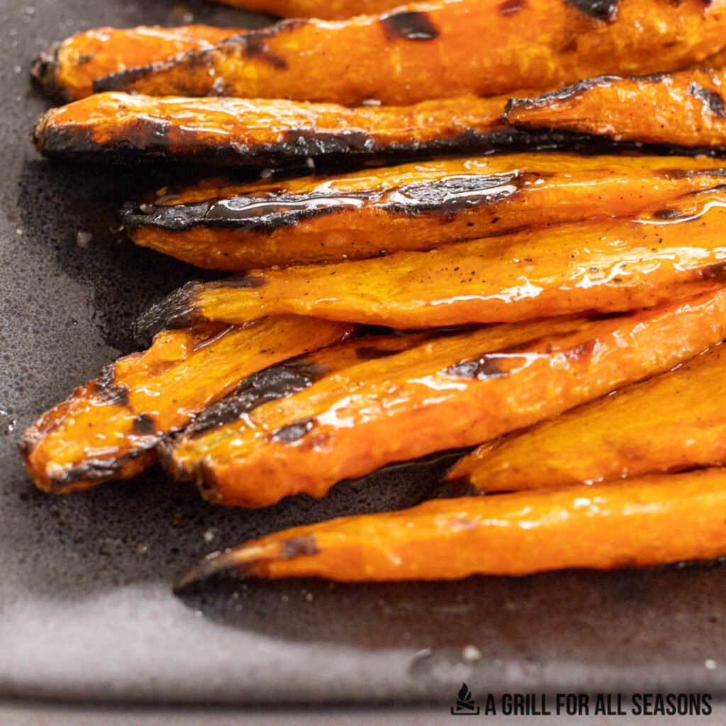 close up of glazed grilled carrots on a platter