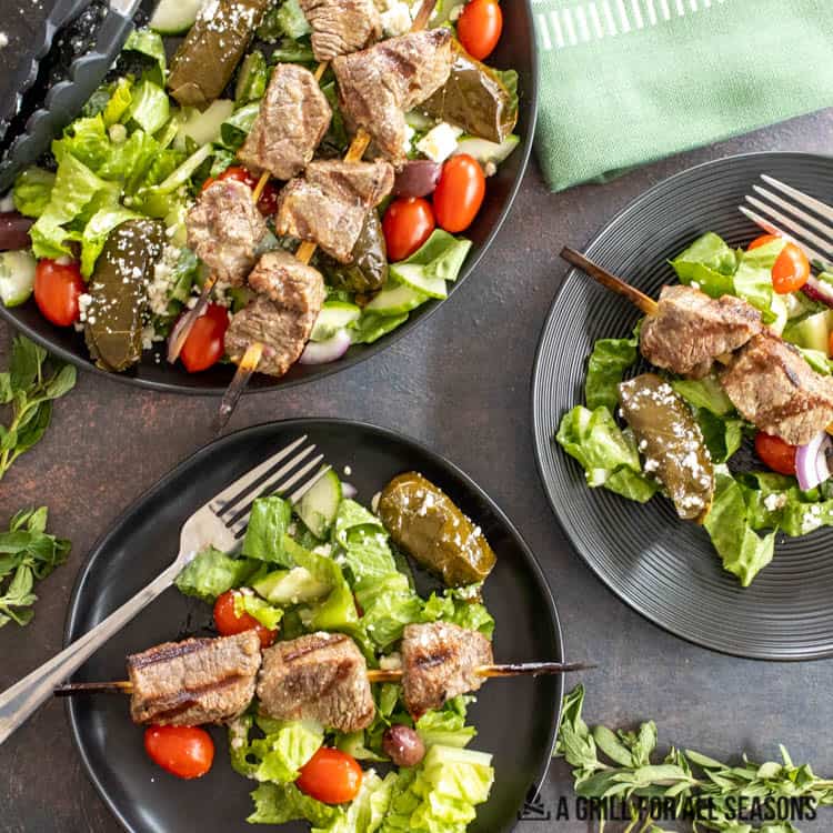 greek steak salad on plates