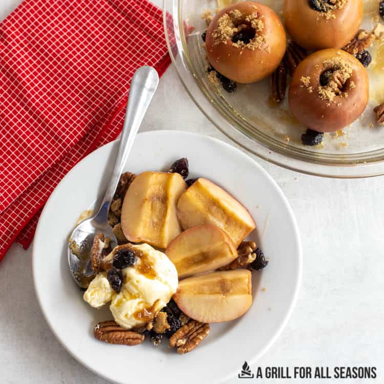 sliced smoked apples served with vanilla ice cream pecans brown sugar and craisins