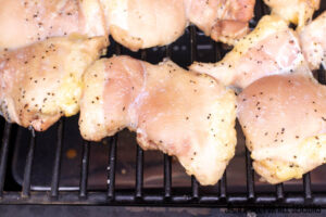 close up of chicken thighs on smoker