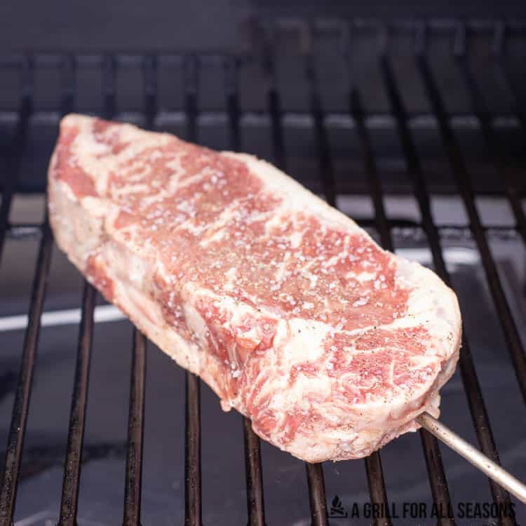 steak on traeger pellet grill with temperature probe