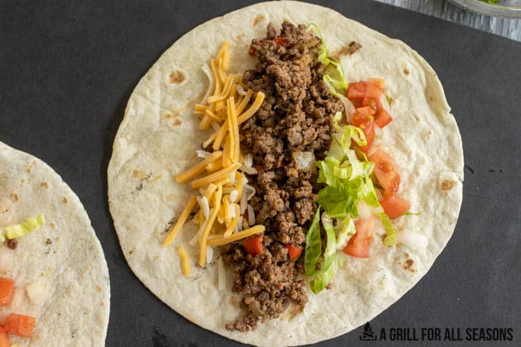 tortilla with meat and toppings for venison tacos