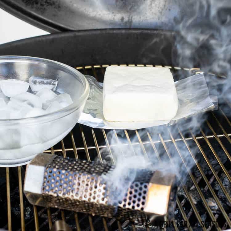 mozzarella on grill with bowl of ice water and smoker tube