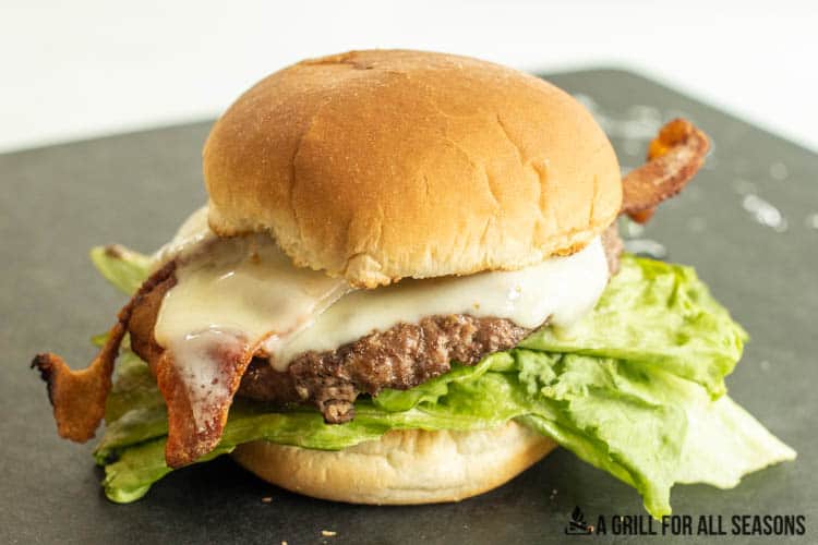grilled frozen burger on top with toppings