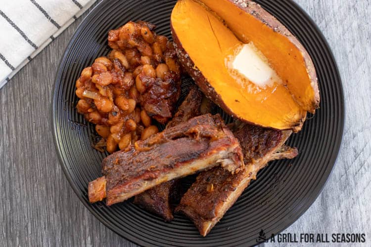 overhead shot of plate with ribs, potato, and smoked beans