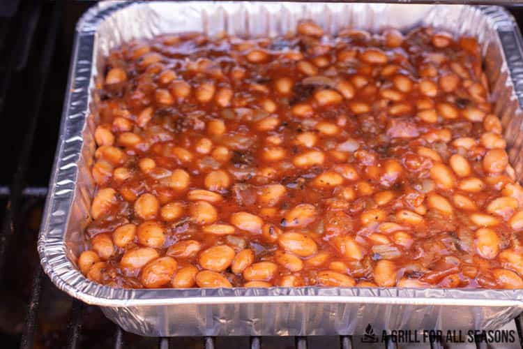 tray of smoked baked beans on traeger grill