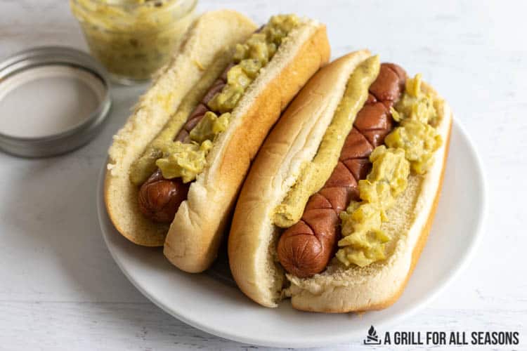smoked hot dogs on buns with mustard and onion relish