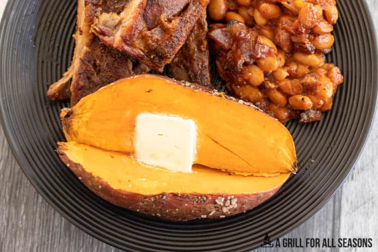 sweet potato cut in half with butter