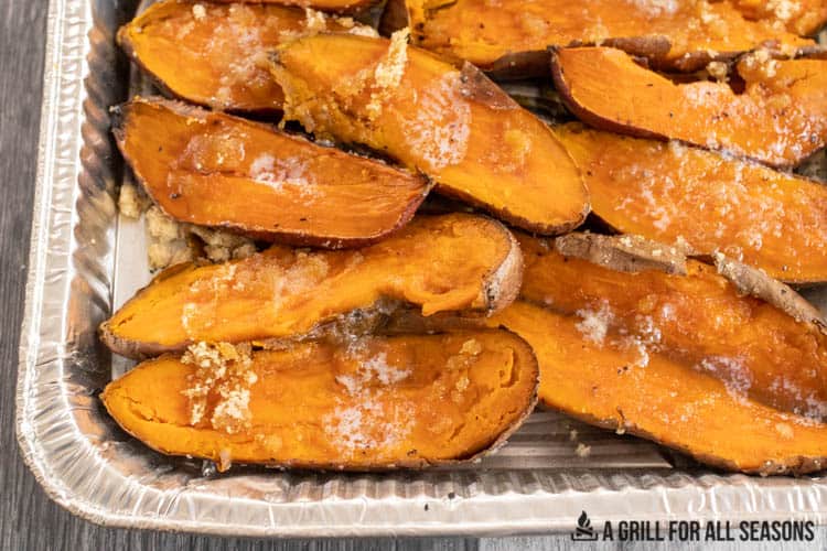 halved smoked sweet potatoes topped with butter and brown sugar