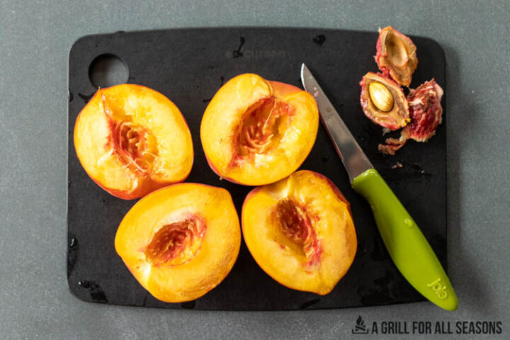halved peaches on cutting board