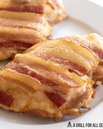 close up of bacon topped smoked chicken breast