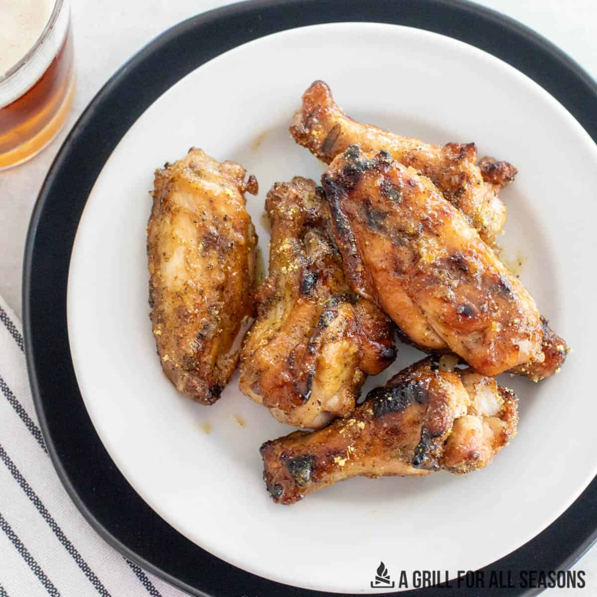 close up of a plate with honey lemon pepper wings