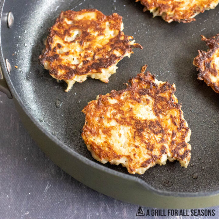 potato fritters frying in skillet
