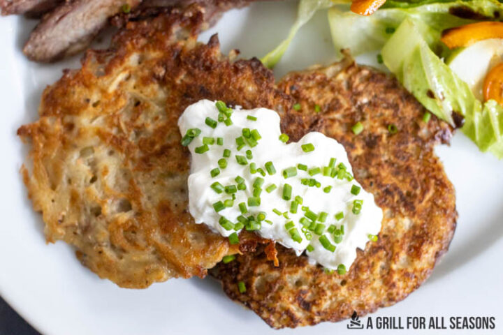 overhead shot of sour cream and chives on the latkes