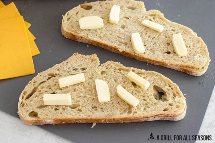 pats of butter on slices of bread