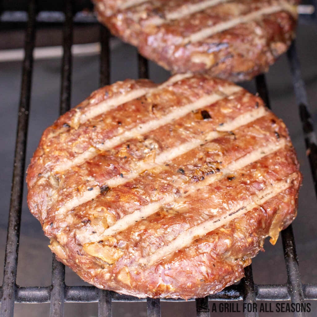 close up of one of the traeger burgers on the pellet grill