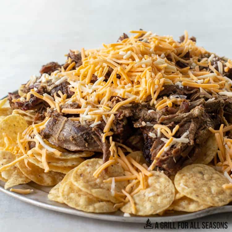 platter with tortilla chips, shredded beef, and shredded cheese