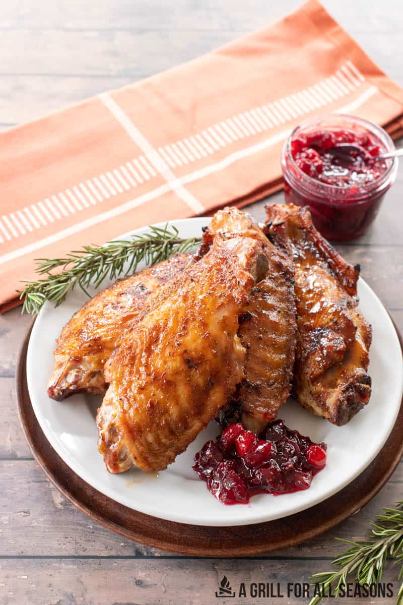 plate with smoked turkey wings and cranberry sauce