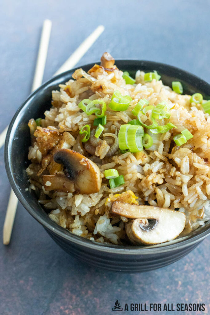 fried rice in bowl with chopsticks