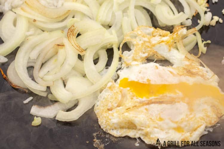 onions and egg cooking on blackstone griddle